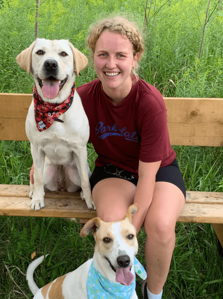 Image of Charlotte with two brown and white dogs